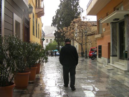 man walking down a marble paved street