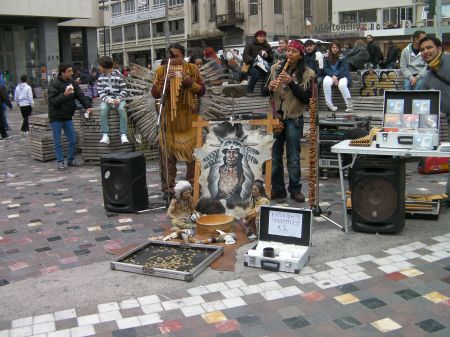 two pan flute musicians dressed like plains indians