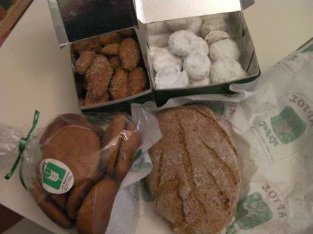 three types of cookies and a loaf of brown bread