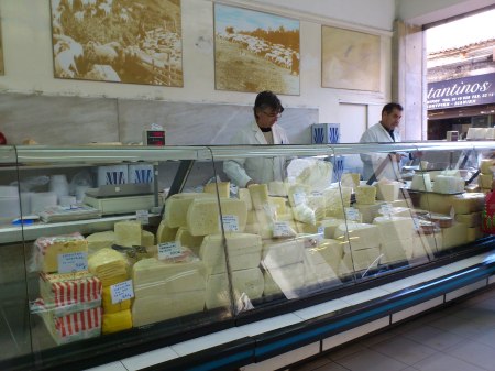 Cheese Shop a cheese shop with glass display case full of cheeses