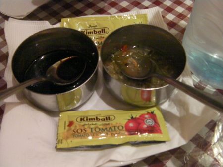 Condiments two metal bowls and ketchup packets