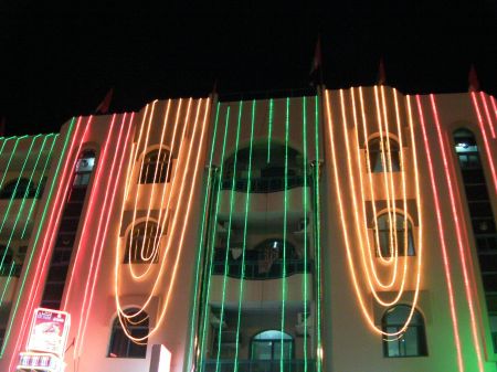 Light drape building draped in red, white and green lights