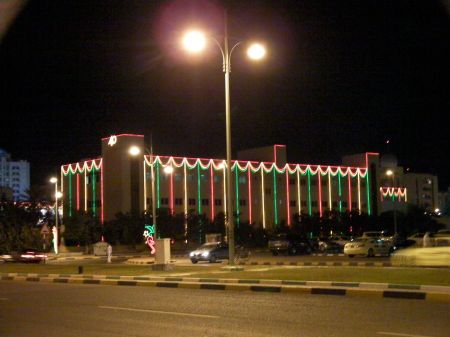 Government Building building draped in red, green and white lights