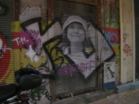 graffiti incorporating a photograph of a girl in a hat