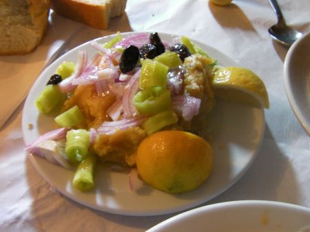 plate of yellow mash with lemon, peppers, olives and onions