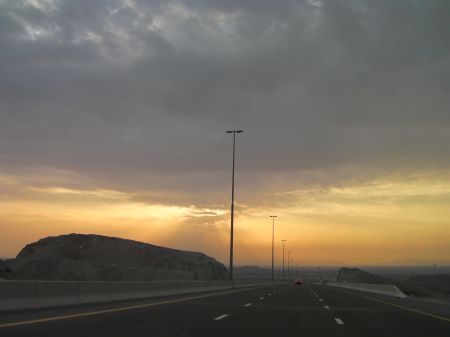 sun shining through clouds on the new Fujairah highway