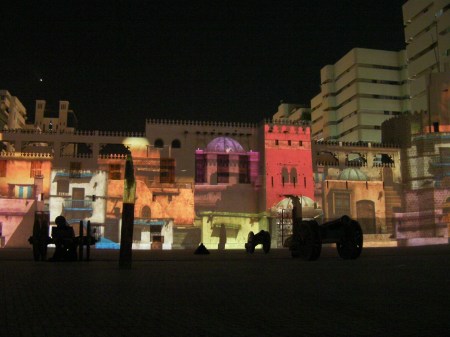 Hisn Fort colorful buildings projected on the side of the fort