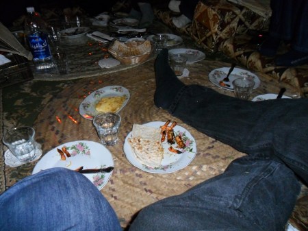 empty dishes and outstretched legs