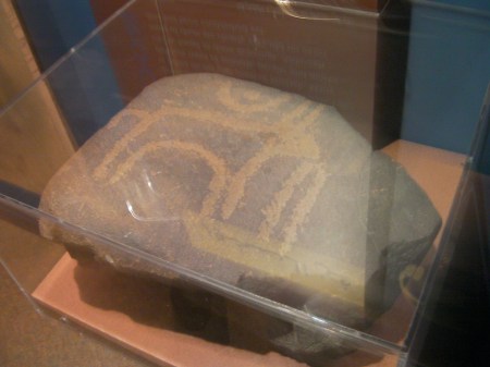 petroglyph of a bull under a crescent moon