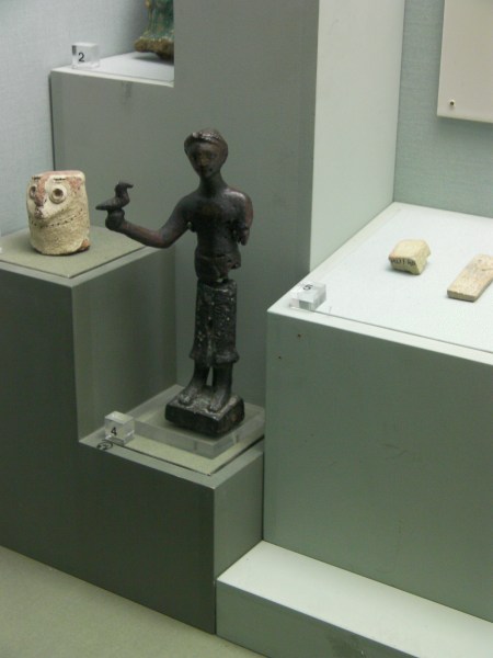 metal sculpture of a man holding a bird