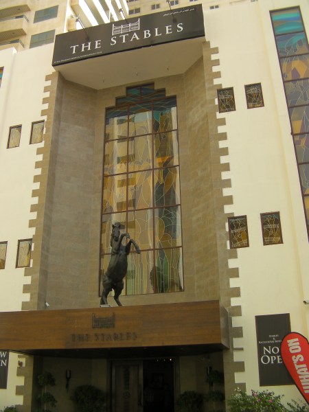 three story building with horse sculpture