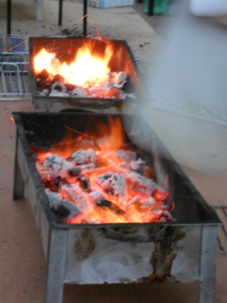 small rectangular metal containers with burning coals