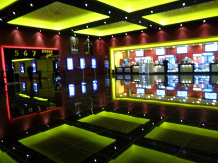 large, colorfully lit cinema lobby area