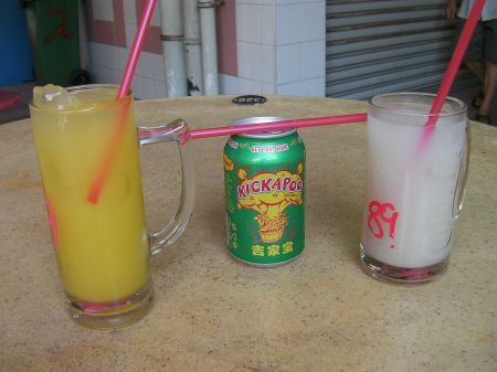 mug of lime juice, can of Kickapoo Joy Juice, and a mug of barley water