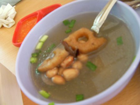 Soup clear broth with green onions, peanuts, lotus root