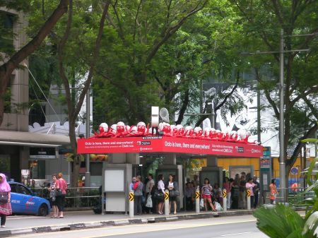 bus stop covered with red octopi figures