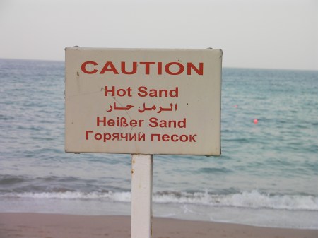 Caution Hot Sand multilingual sign warning of hot sand