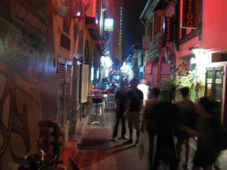 busy pedestrianized alley with lots of shops and restaurants