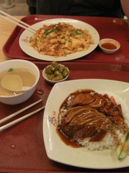 a large omelette and plate of rice, duck and pork