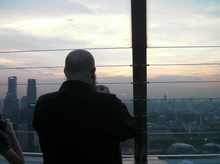 man taking a picture of the sunset