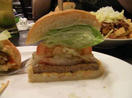 burger with lots of fixings cut in half