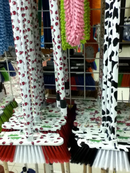 Brooms brooms covered in ladybug design or black and white spotted cow design
