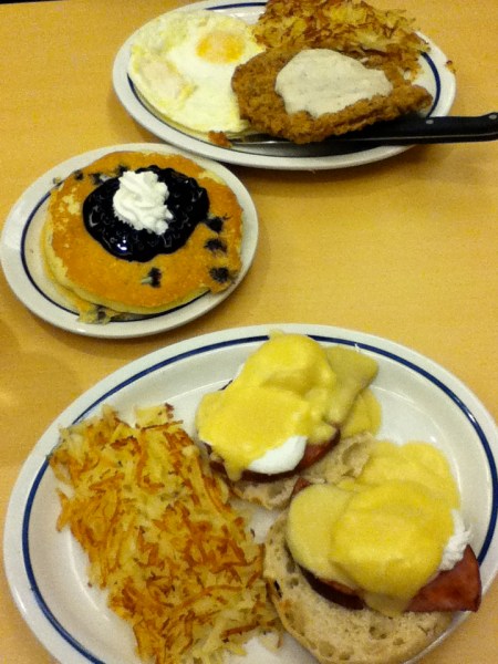 Breakfast eggs benedict, hash browns, blue berry pancakes, country fried steak, fried eggs