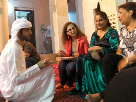 Conversation young Emirati man talking with three women