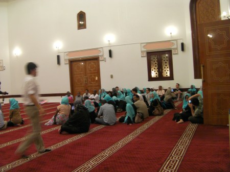Mosque 2 approximately 50 people seated on the floor in the mosque