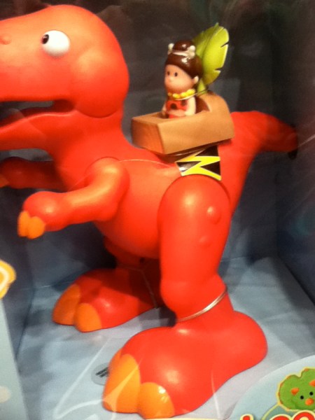 Orange Dinosaur toy dinosaur being riden by a cavewoman