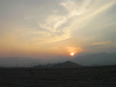 light clouds, orange sunset, shadowy mountains