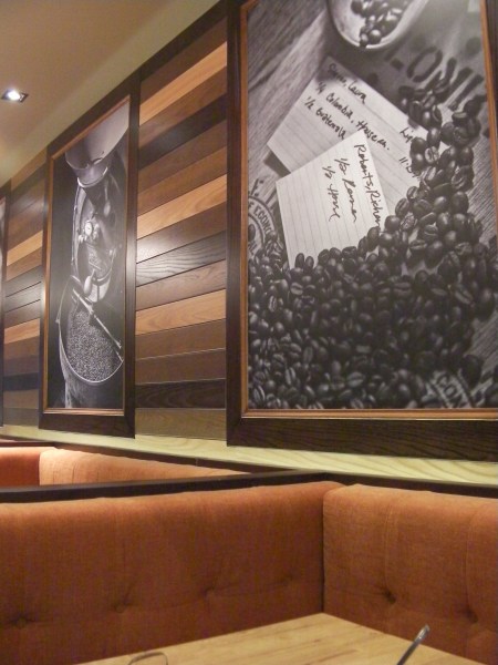 orange upholstered booths and frame coffee pictures