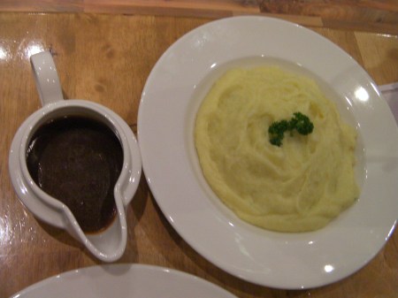 bowl of mashed potatoes, pitcher of gravy