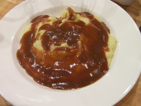 bowl of mashed potatoes with gravy on top