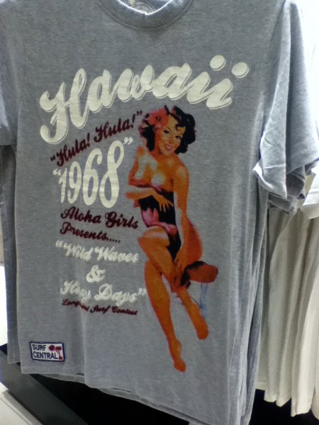 t-shirt with a scantily clad woman and lettering stating Hawaii hula hula 1968 aloha girls presents wild waves and hazy days