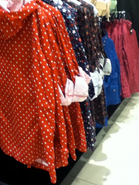 colorful, unlined rain coats on the store rack