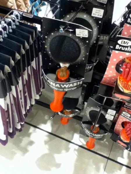 dish scrub sponge on a handle shaped like Diana Ross with the sponge as her afro hairdo