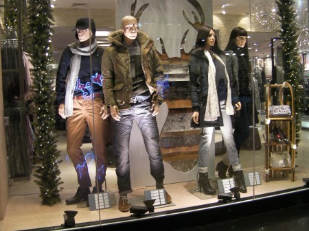 store window with manikins dressed in winter clothes