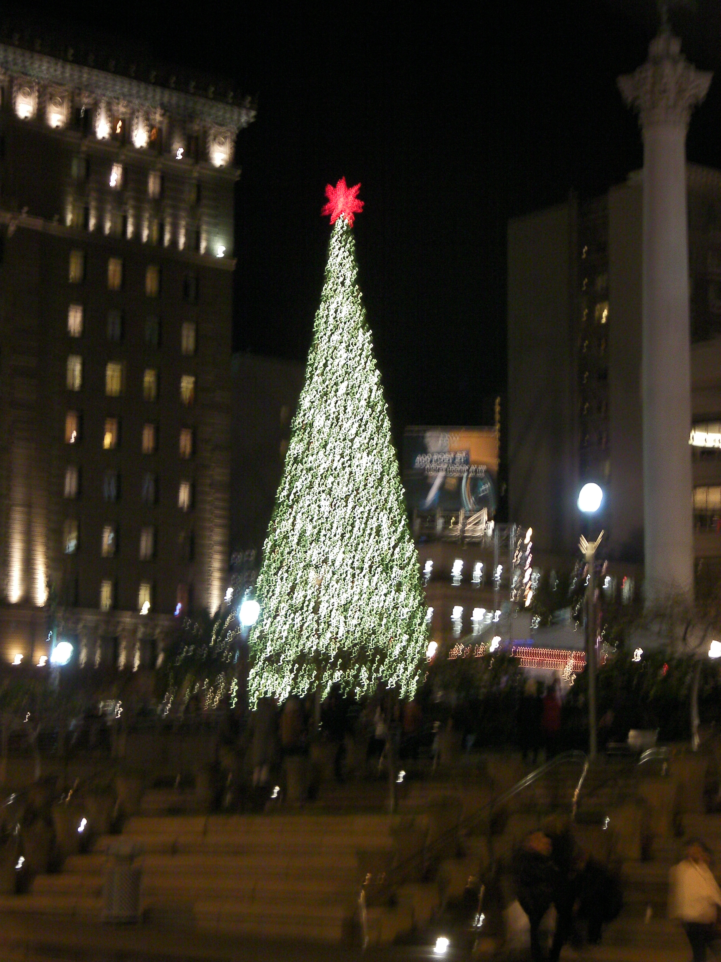 large lighted tree with red star at the top