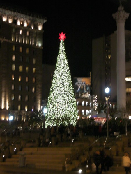 large lighted tree with red star at the top