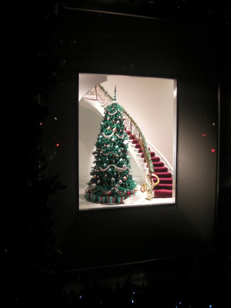 window display with a Christmas tree next to a staircase