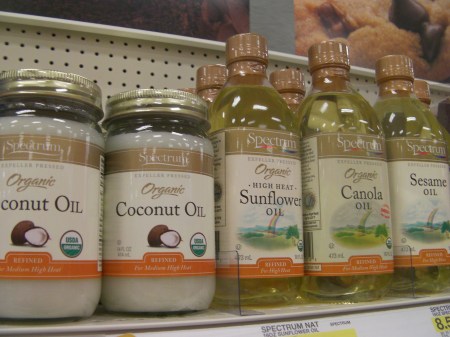 coconut oil, safflower oil, canola oil, sesame oil on store shelf