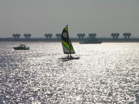 a small sailboat, motor boat and yacht on the waters