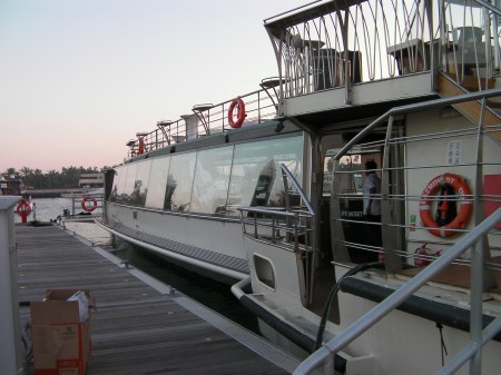 long boat with glassed in lower level and open deck on top