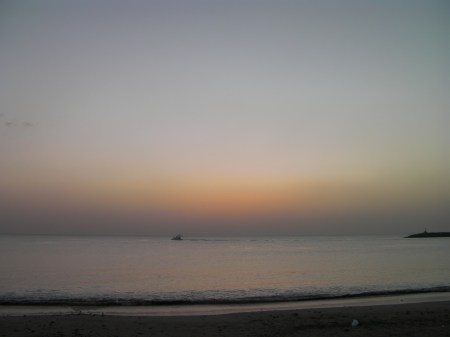 ocean and an orange glow on the horizon