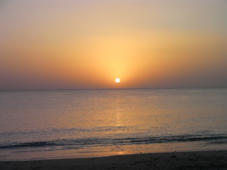 ocean, orange haze, sun fully above the horizon