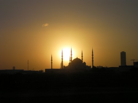 mosque with sun directly behind it