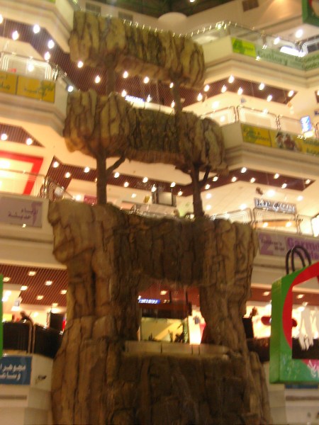 three floors of shopping mall with fake stone waterfall