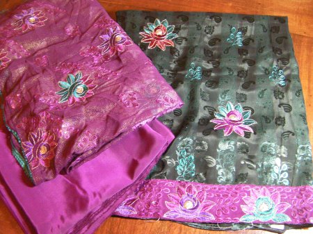black fabric with teal and pink flower embroidery, pink fabric with flower embroidery, plain pink fabric