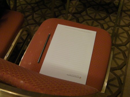 chair with a paper tablet and pencil on it